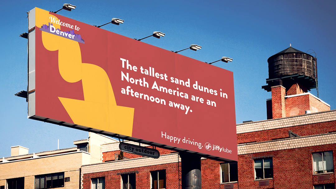 The copy reads: Welcome to Denver. The tallest dunes in North America are an afternoon away. Happy driving. Jiffy Lube.